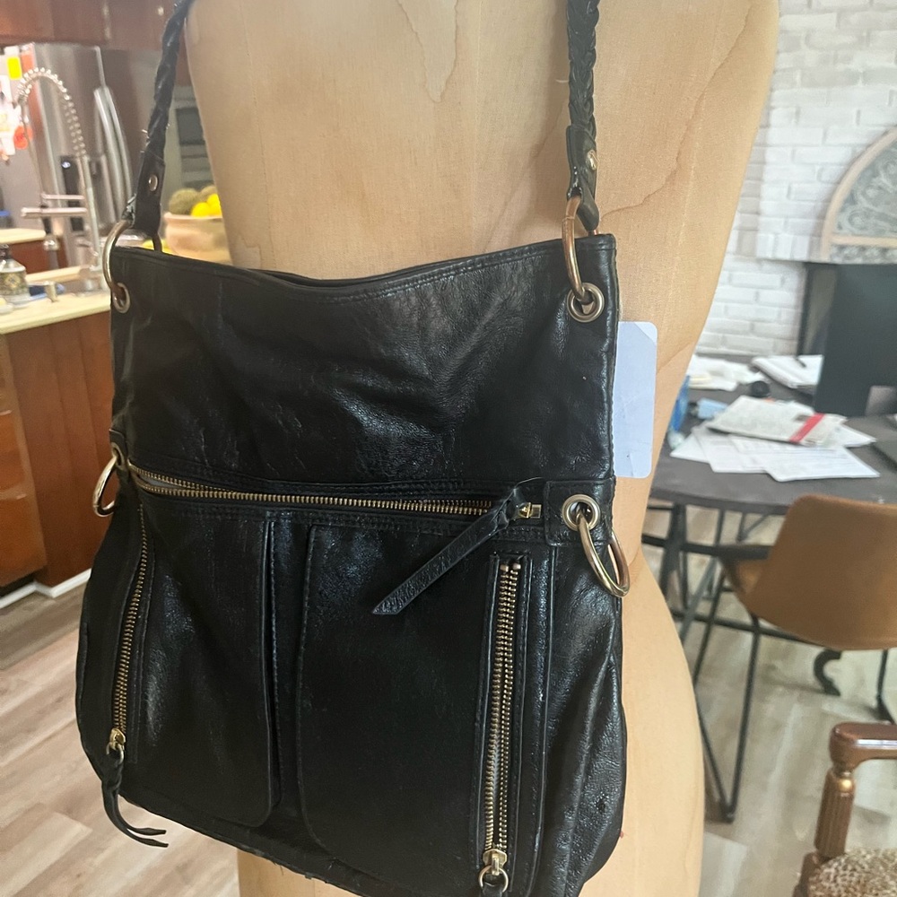 Sak brand black leather bag.  Handle has some wear